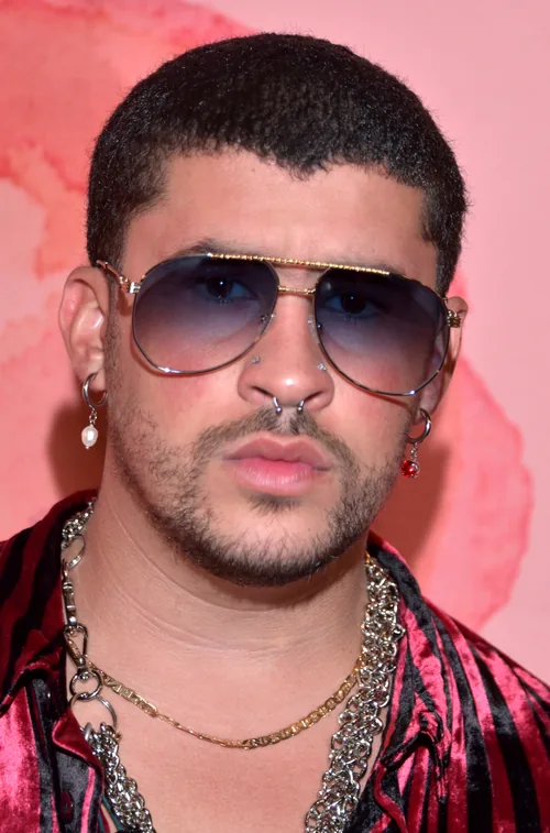 Bad Bunny in tinted aviator sunglasses and a velvet shirt, photographed in Los Angeles in October 2019