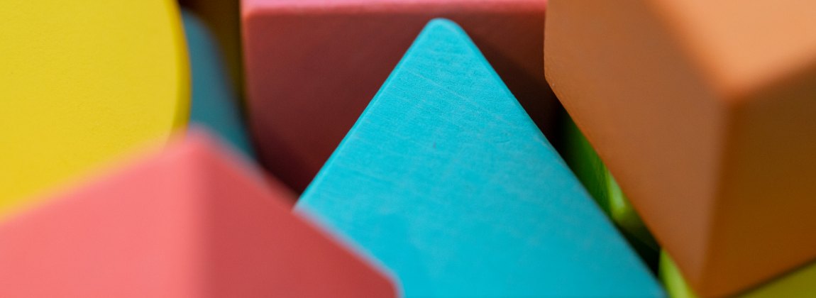 Colourful wooden toy blocks in different shapes