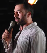 Joe Rogan performing stand-up comedy with a microphone