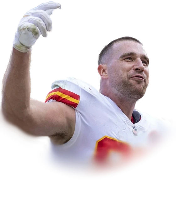 Travis Kelce in his Kansas City Chiefs jersey raising a gloved hand to the crowd in October 2021