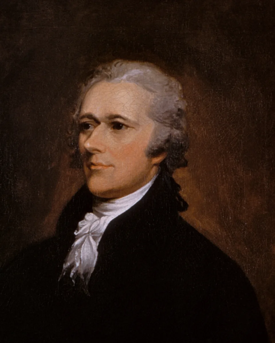Alexander Hamilton in a black coat and white cravat, with powdered gray hair swept back, turned in three-quarter view, in John Trumbull’s oil portrait of 1805