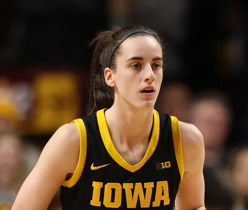 Caitlin Clark with her hair tied back in a black Iowa jersey during a game in February 2024