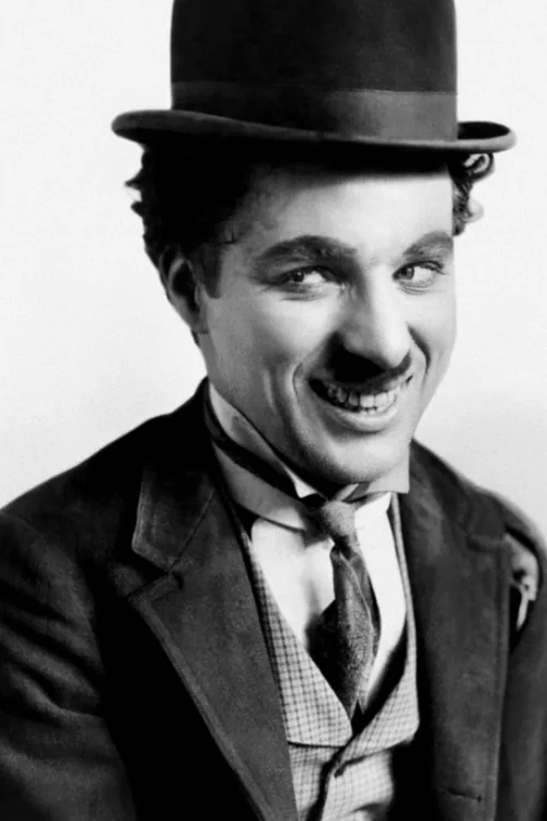 Charlie Chaplin smiling in his Tramp costume and bowler hat in a photograph from 1915
