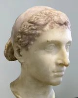Marble bust of Cleopatra VII in three-quarter view, with a royal diadem band across waved hair gathered in a knot at the back, in the Altes Museum, Berlin