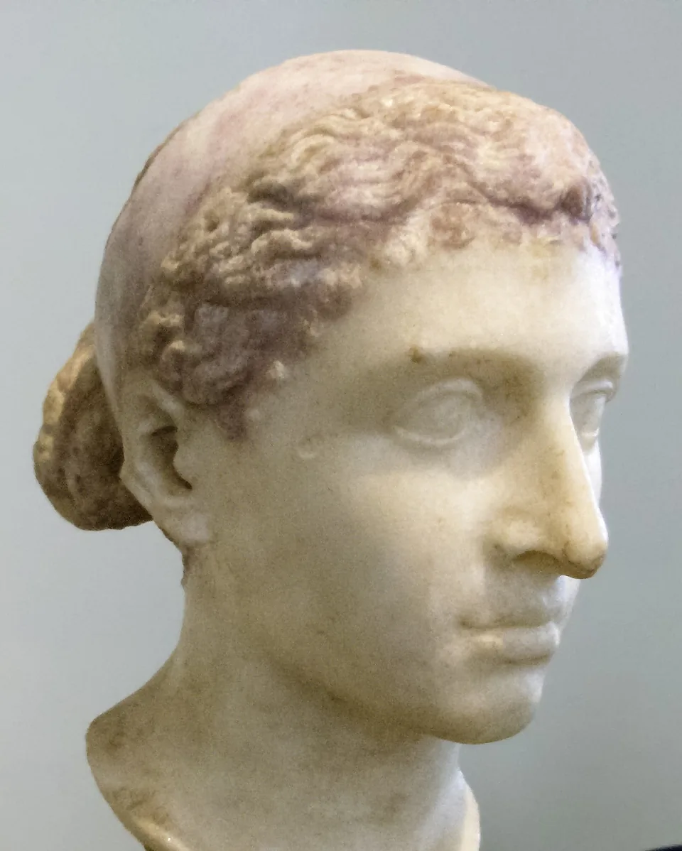 Marble bust of Cleopatra VII in three-quarter view, with a royal diadem band across waved hair gathered in a knot at the back, in the Altes Museum, Berlin