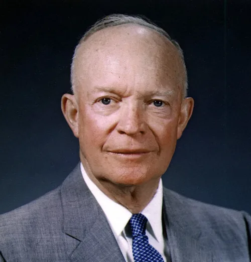 Dwight D. Eisenhower in a gray suit, white shirt and blue polka-dot tie, in his official presidential portrait of May 29, 1959