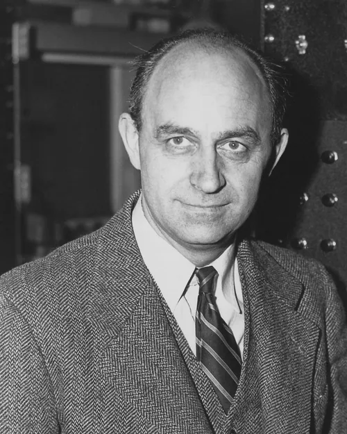Enrico Fermi standing in front of laboratory control equipment in a photograph from the 1940s