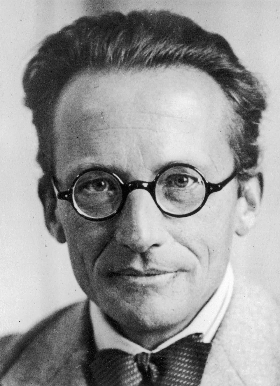 Erwin Schrödinger in round glasses and a bow tie in a photograph from 1933