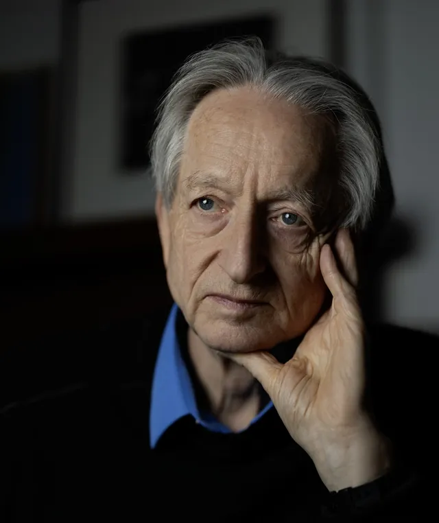 Geoffrey Hinton resting his head on his hand, photographed in May 2026