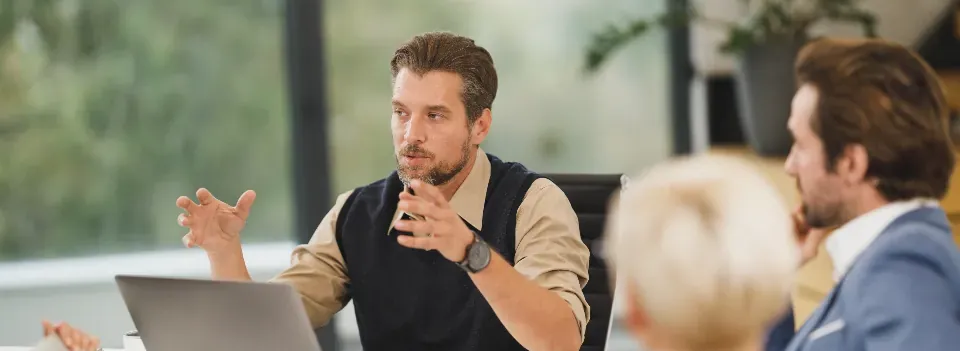 A manager explaining a decision to colleagues in a team meeting