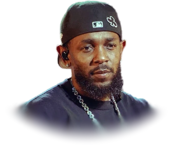 Kendrick Lamar in a black baseball cap and a dark T-shirt with a chain necklace, performing in July 2025