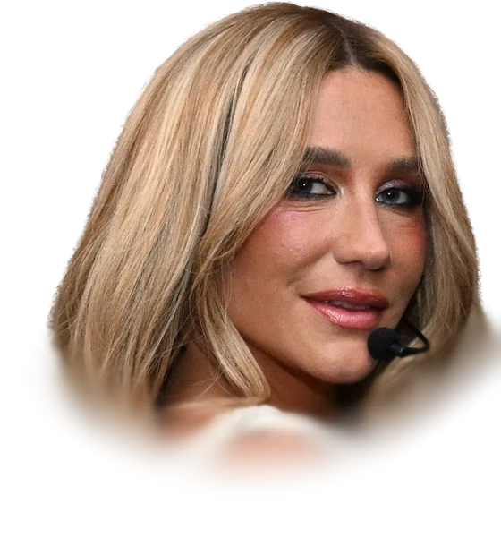 Kesha with long blonde hair and a headset microphone at a concert in September 2025
