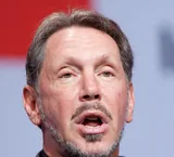 Larry Ellison speaking into a microphone at an Oracle event