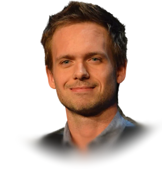 Patrick J. Adams, the actor who played Mike Ross in Suits, with tousled hair and light stubble, in a gray button-up shirt and black vest at a Suits promotional event in January 2013