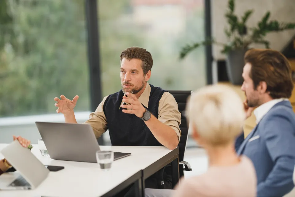A manager explaining a decision to colleagues in a team meeting