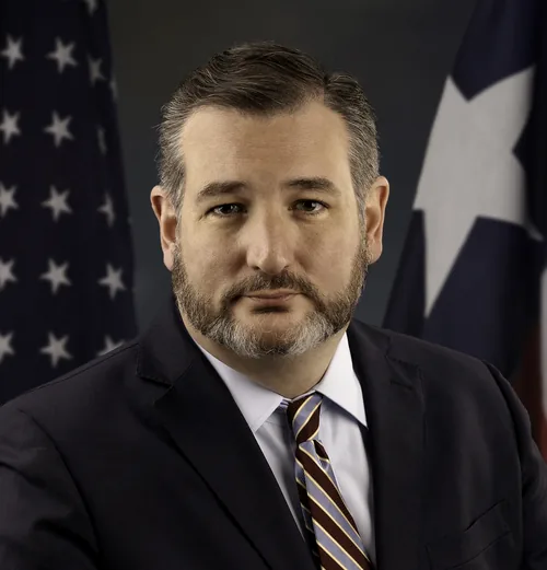 Ted Cruz with a trimmed dark beard in a dark suit, white shirt and striped tie, in his official U.S. Senate portrait from January 2019