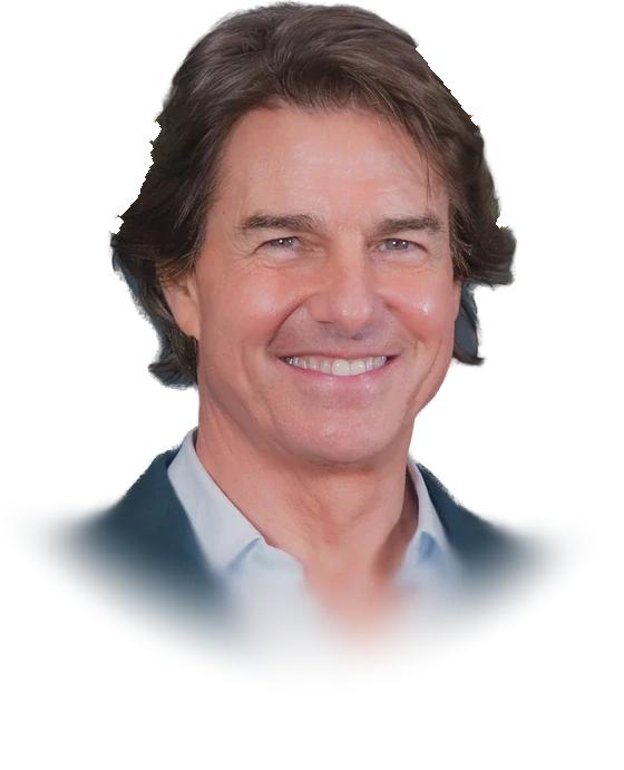 Tom Cruise smiling, with swept-back brown hair and a teal jacket over a light blue open-collar shirt, at the 53rd Saturn Awards in March 2026