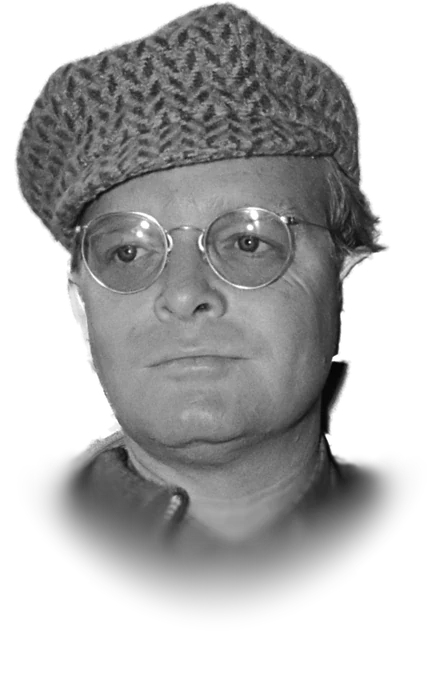 Truman Capote in round wire-rimmed glasses and a knitted cap, looking at the camera in a black-and-white photograph from March 1968