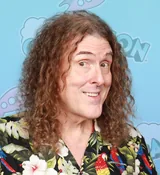 Weird Al Yankovic with long curly hair in a parrot-print shirt at GalaxyCon St. Louis in October 2025