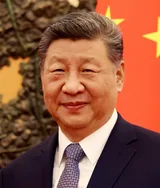 Xi Jinping in a dark suit, white shirt and gray patterned tie, smiling slightly, in a photograph taken in Beijing on January 29, 2026
